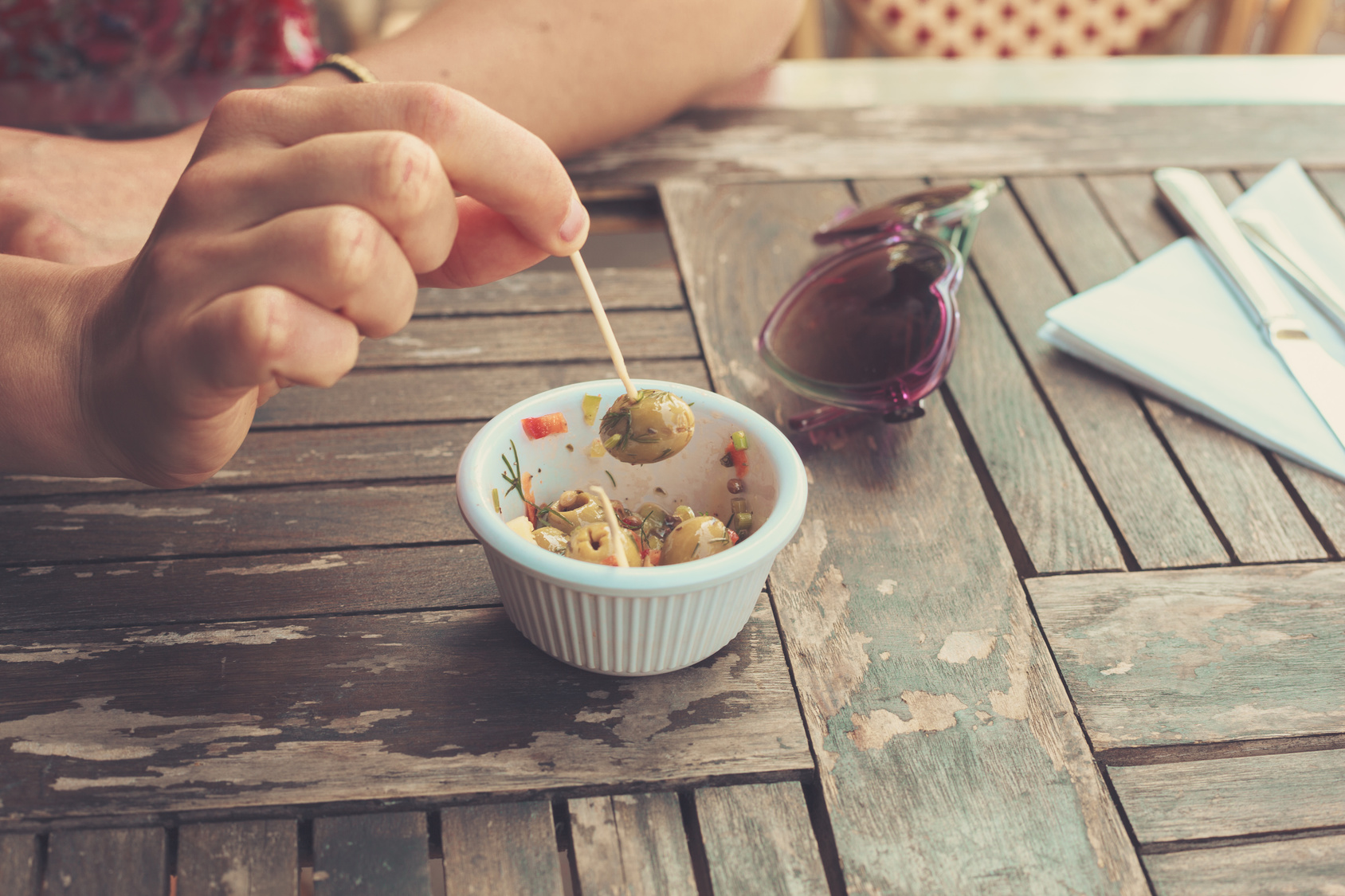 Woman eating olives outside