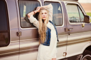 beautiful girl model posing on a background of the bus