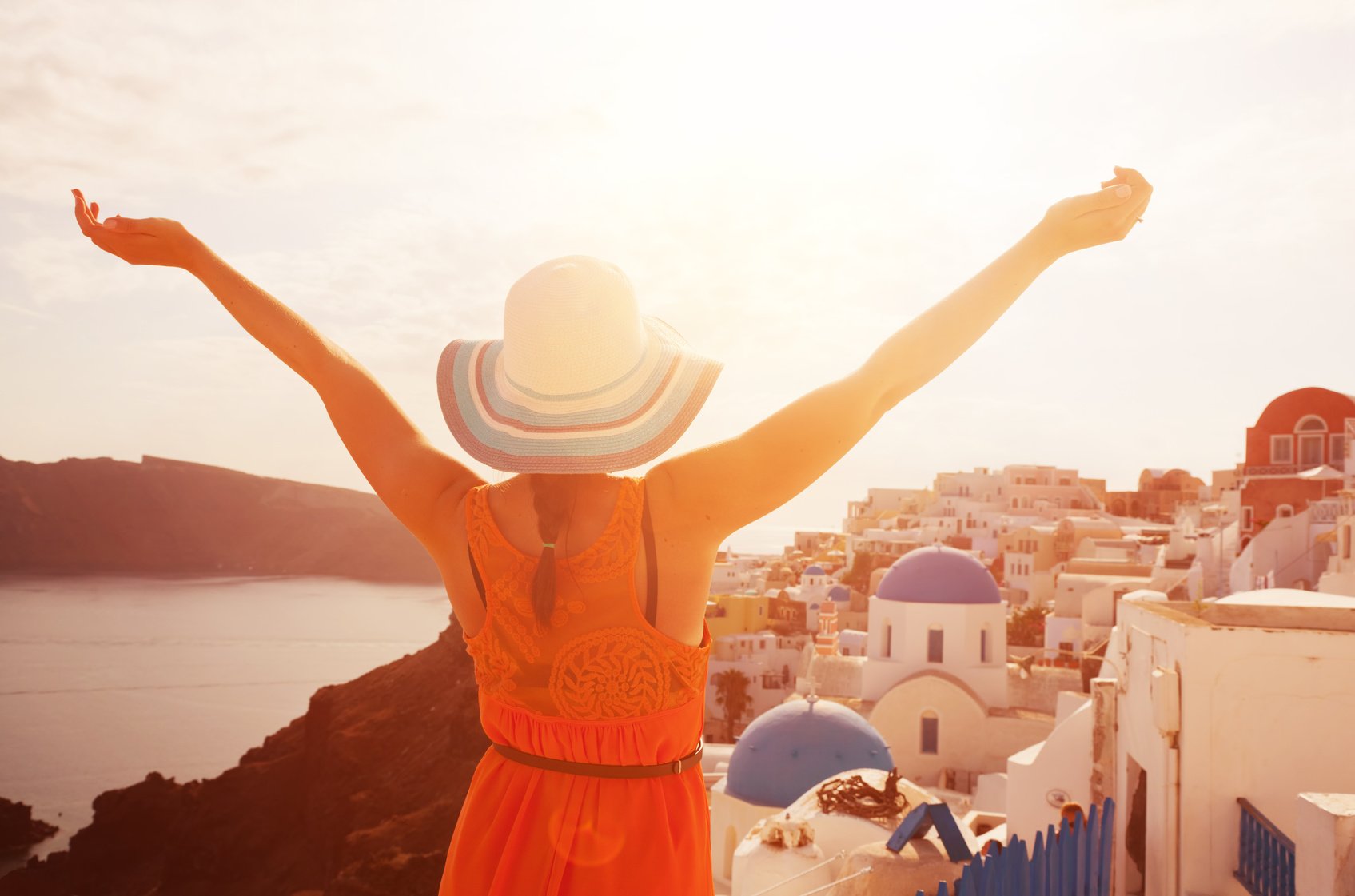 Happy woman enjoying her holidays on Santorini, Greece