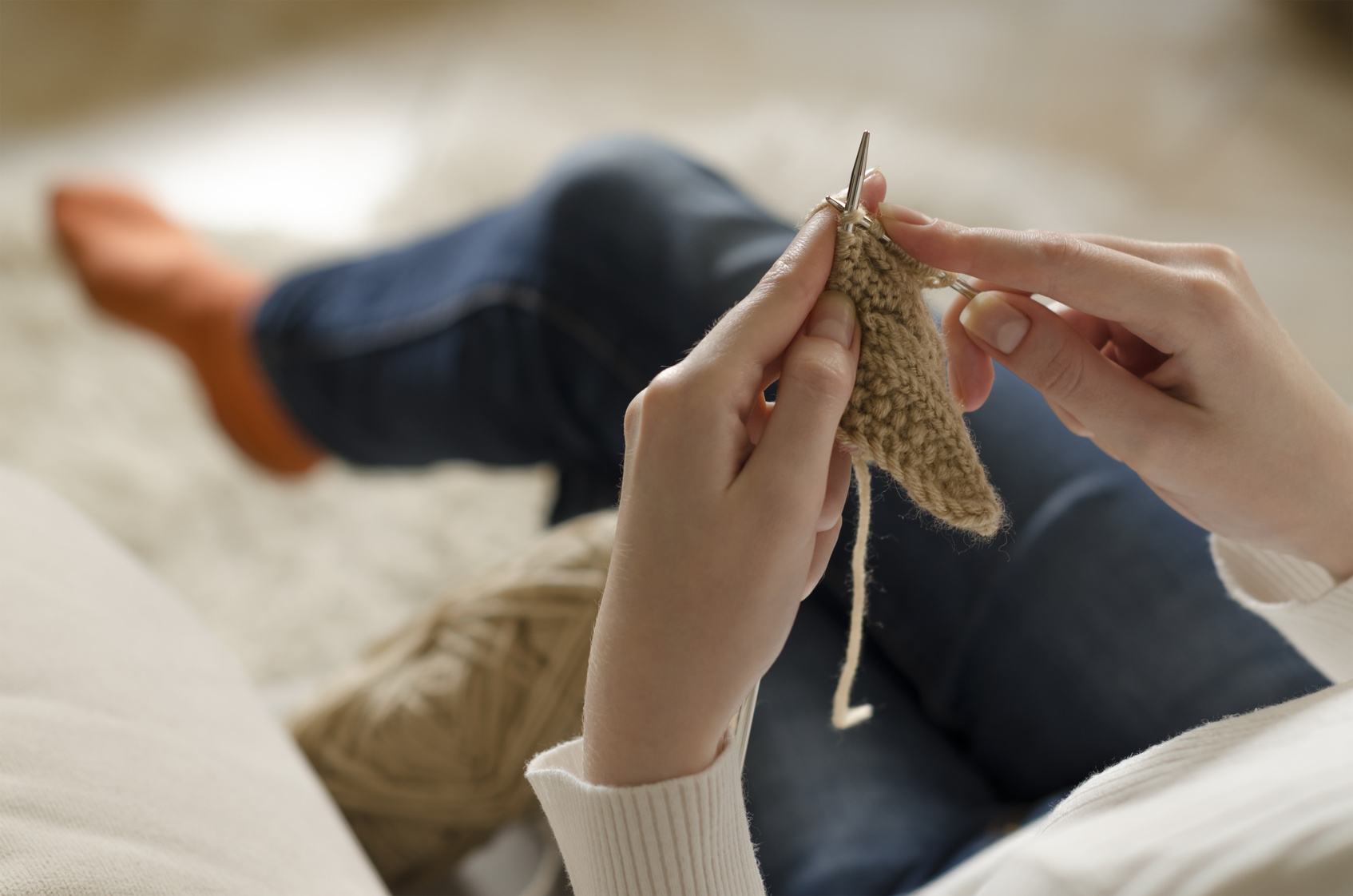 Hands of a young woman knitting. Closeup