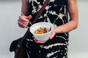 Young woman with bowl of squid