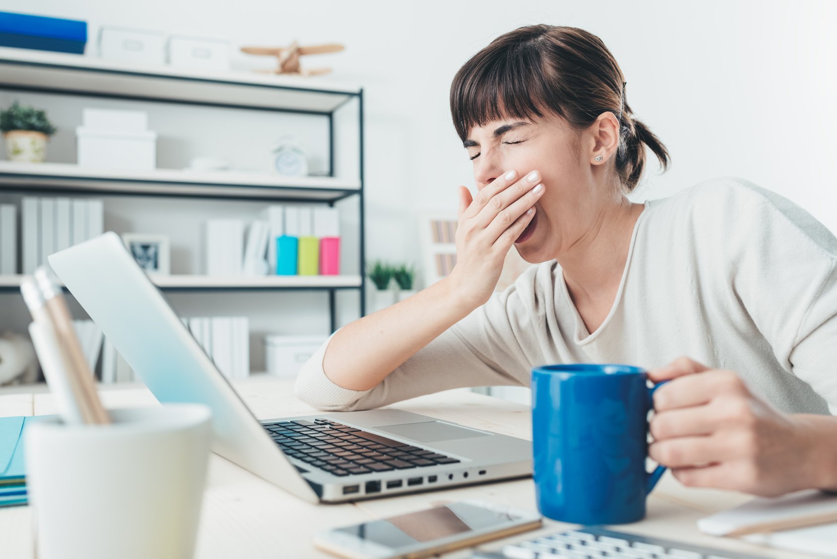 Tired woman at office desk