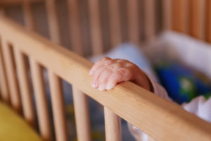baby hand closeup cot