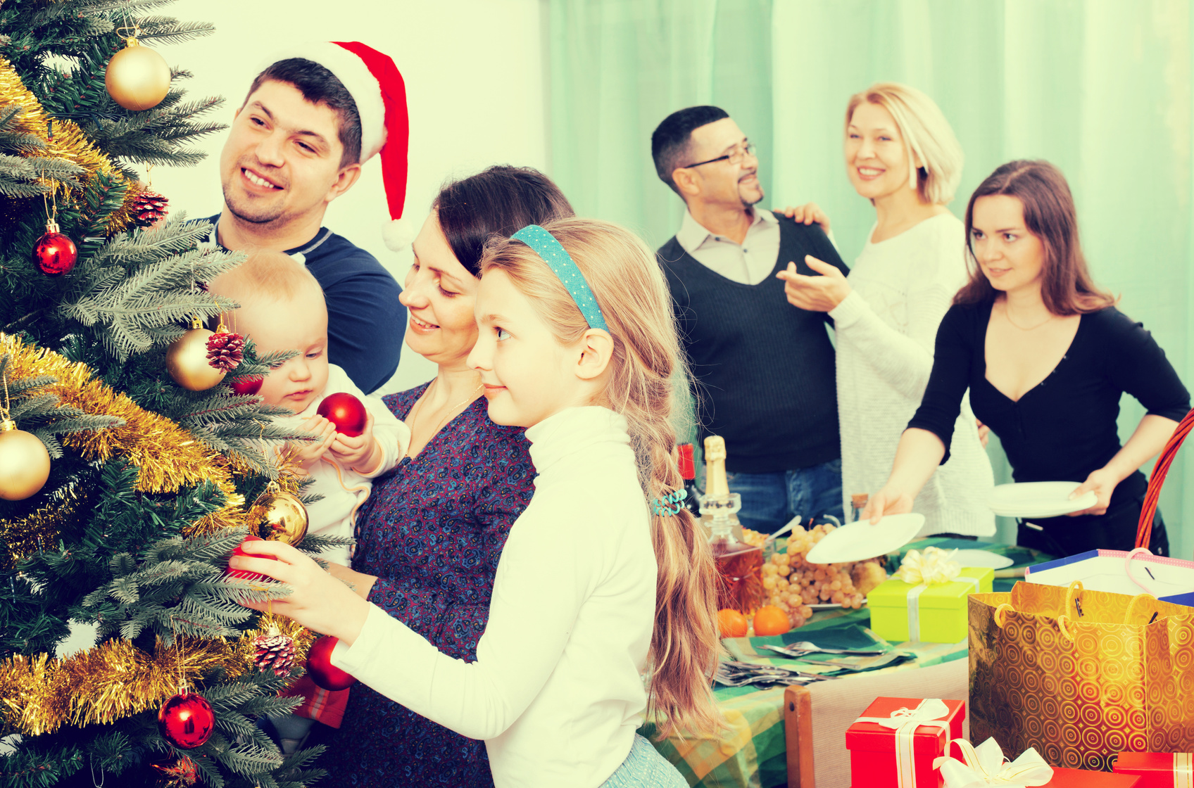 Happy family with Christmas tree at home.