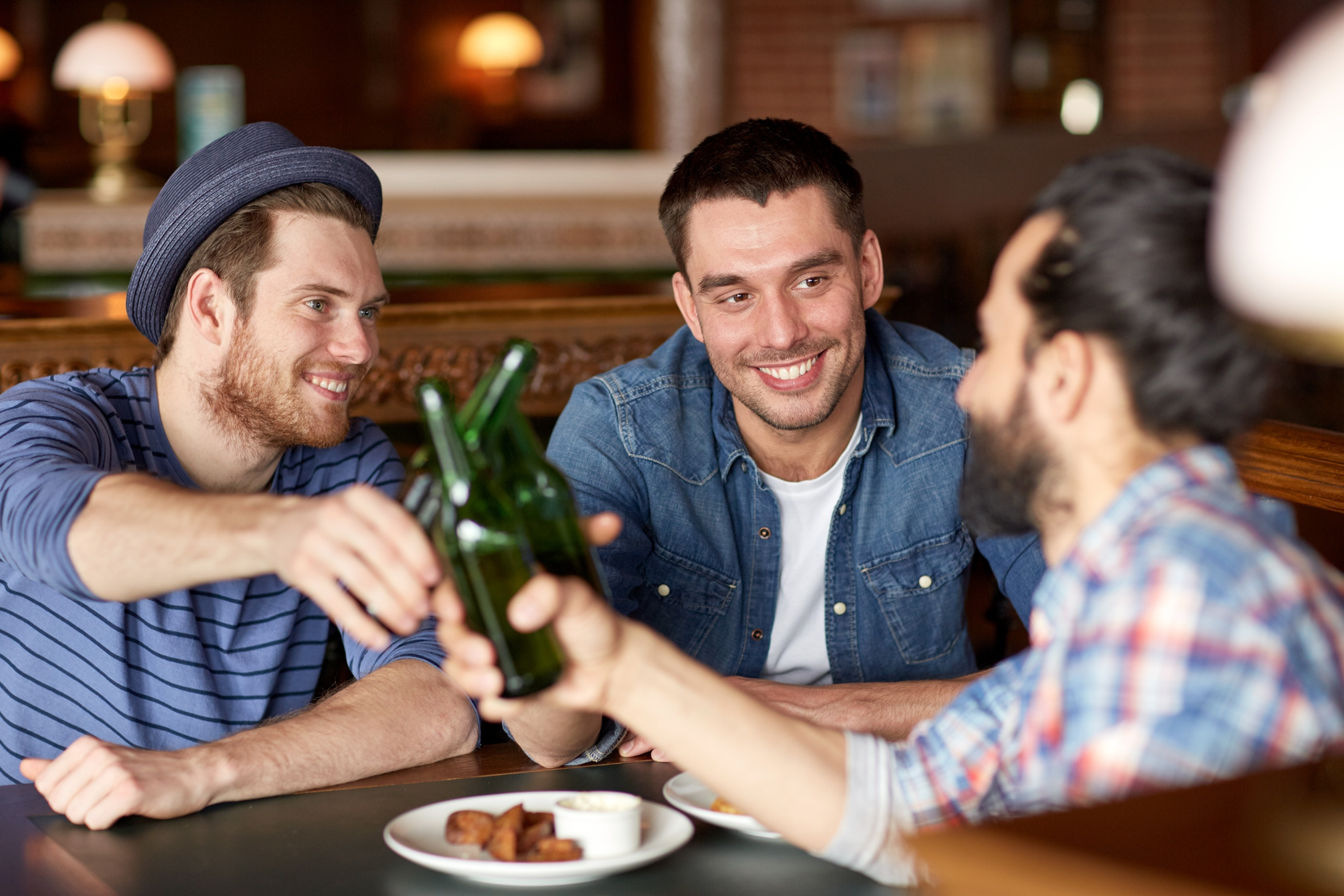 happy male friends drinking beer at bar or pub