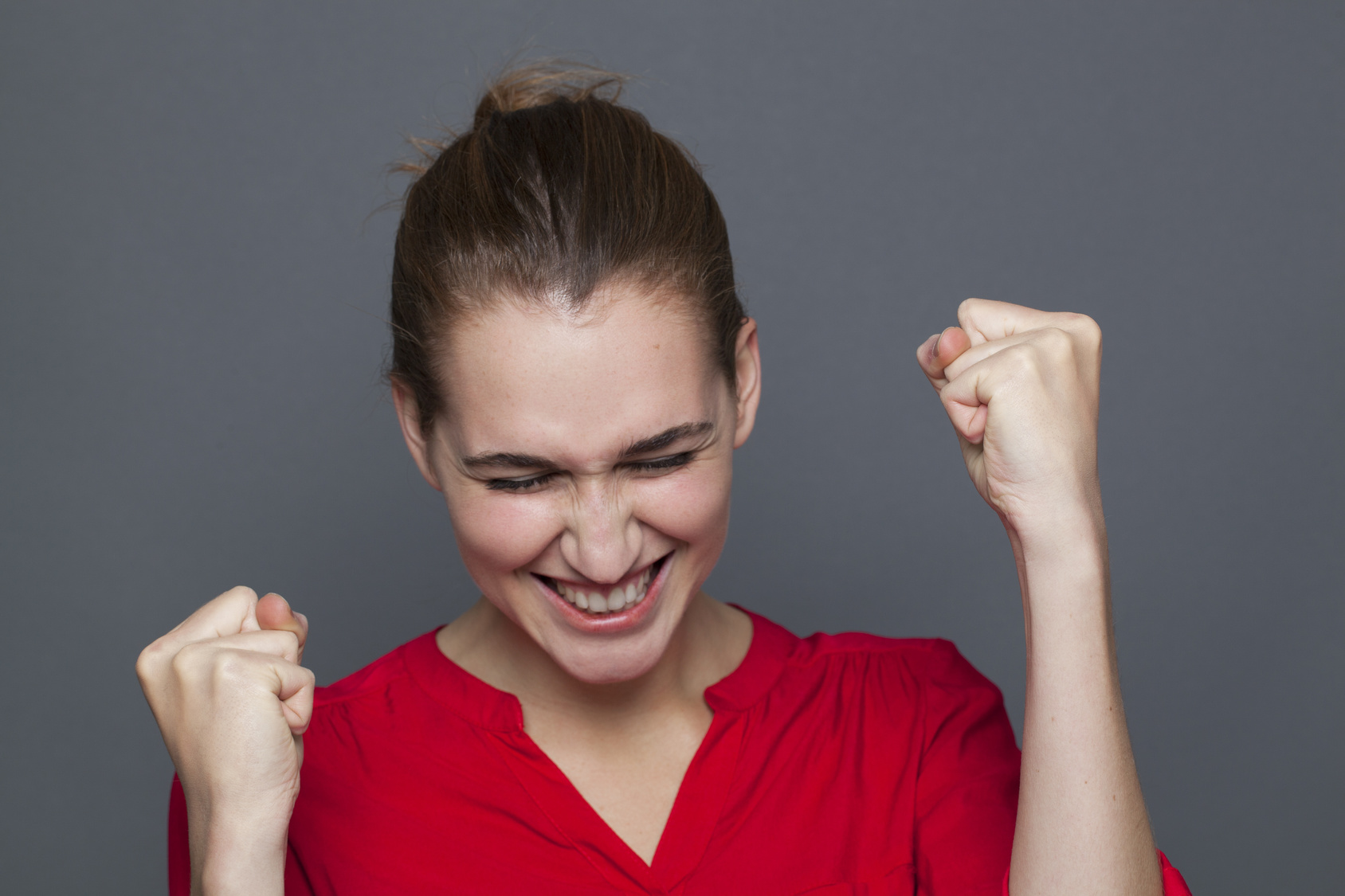 giggling young woman gesturing to express fun excitement