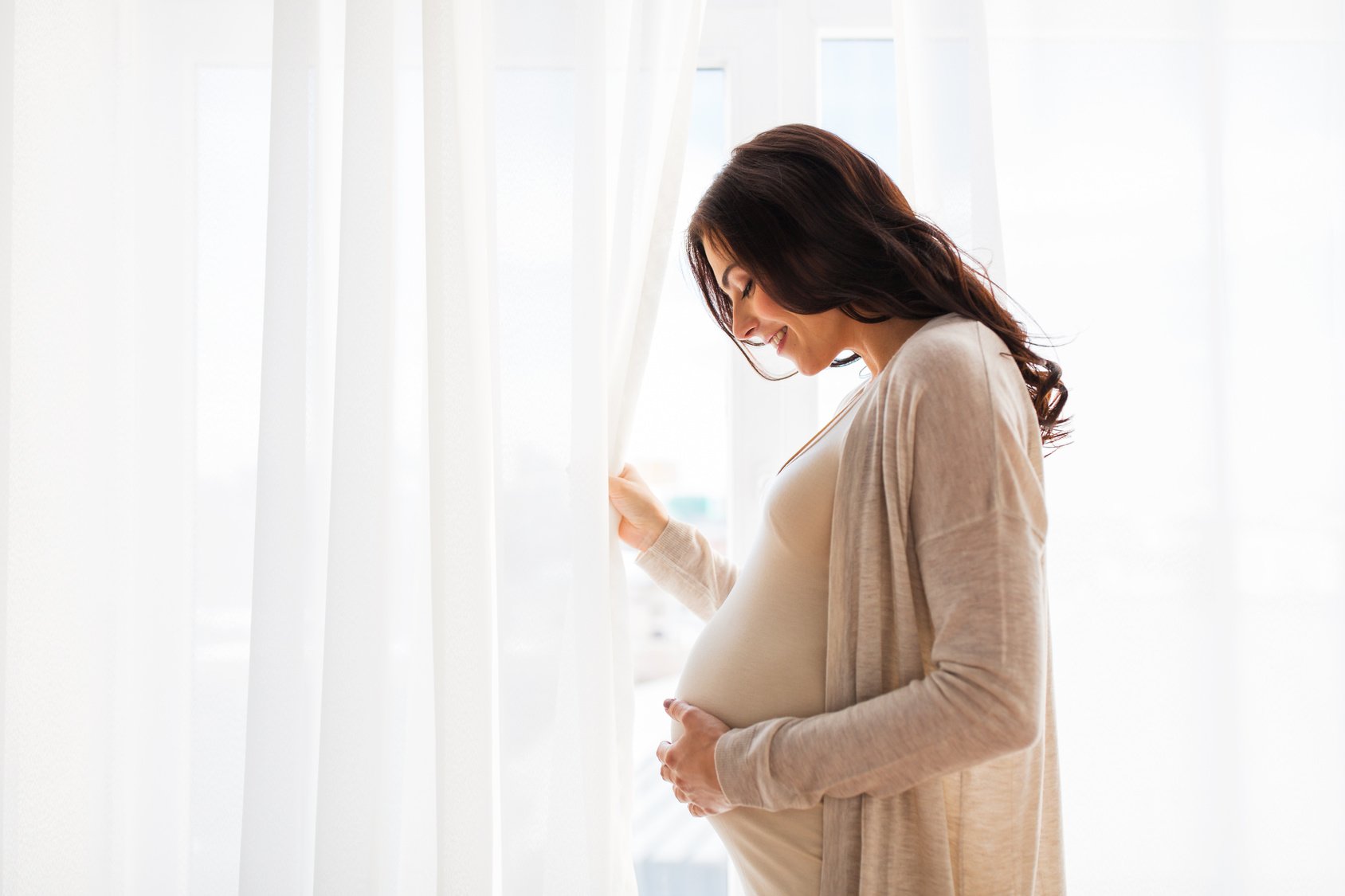 close up of happy pregnant woman with big belly