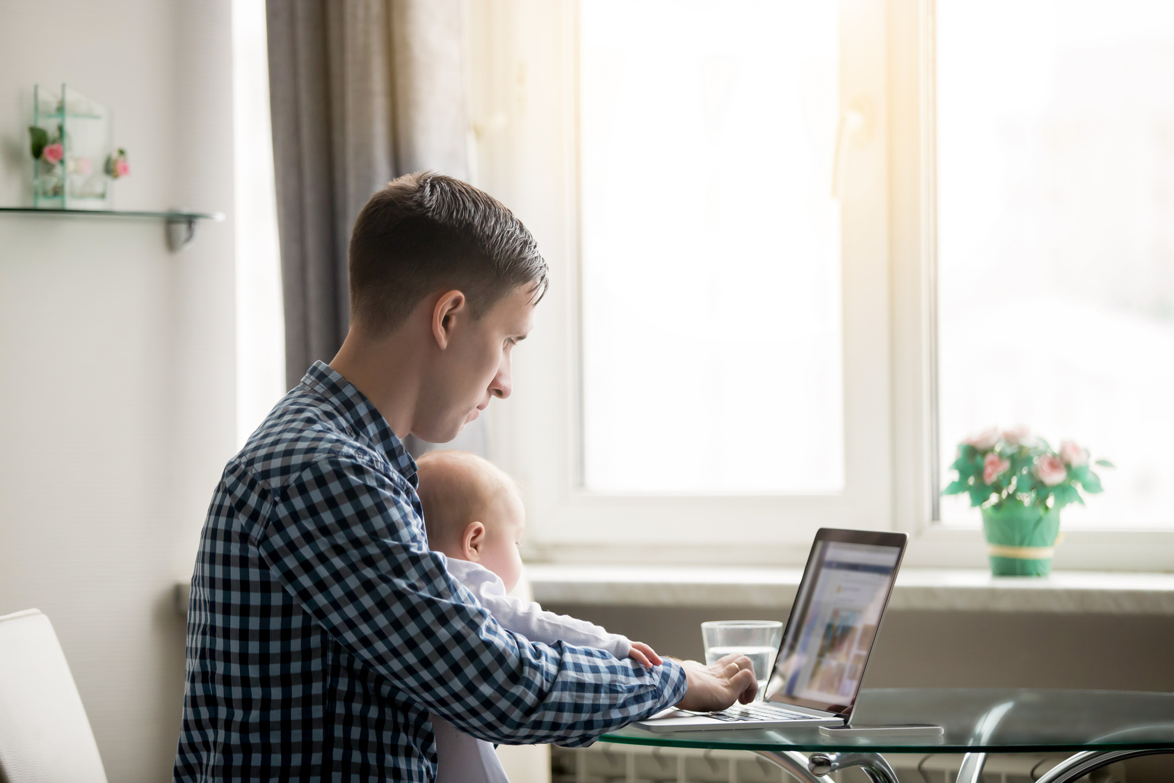 Man and a baby at the laptop