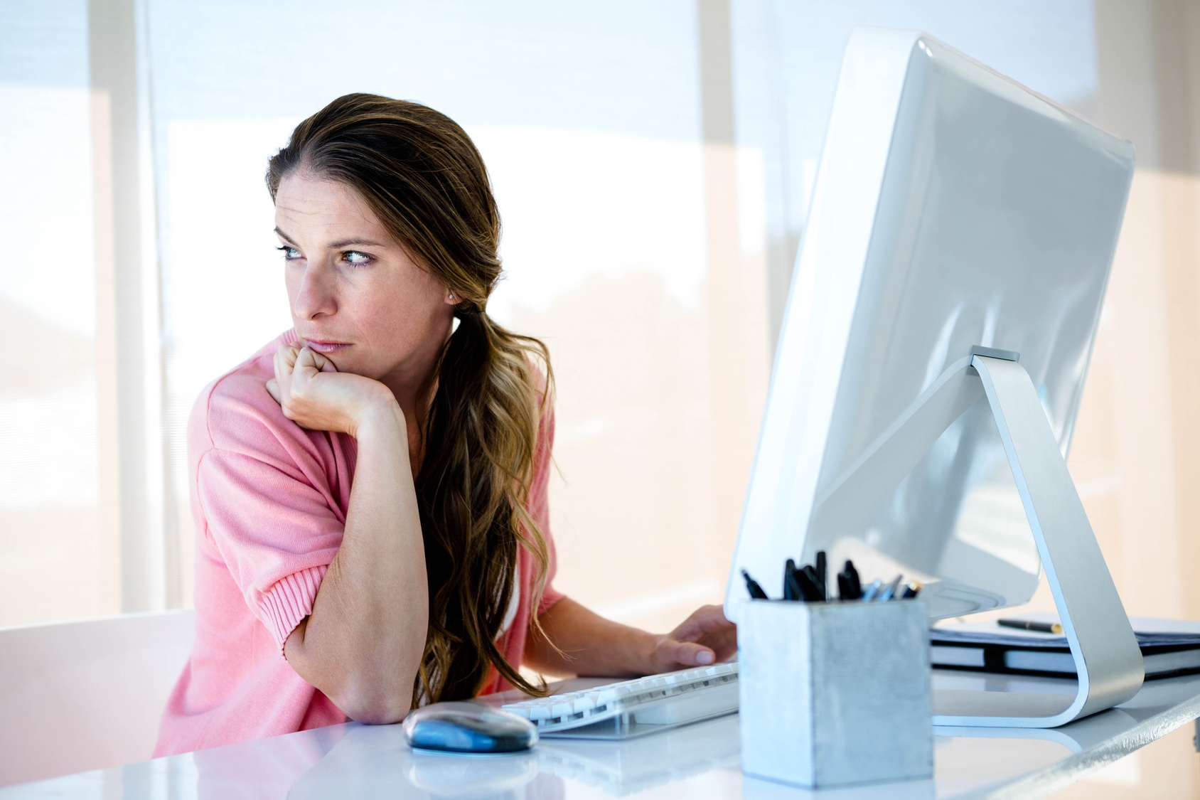 distracted business woman looking away from her computer