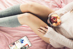 Woman having breakfast in bed