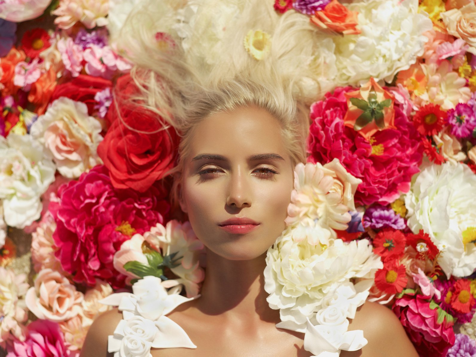 Beautiful lady lying in flowers