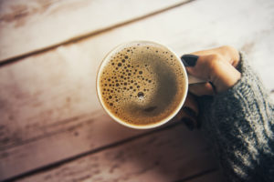 Girl holding a cup of coffee in winter