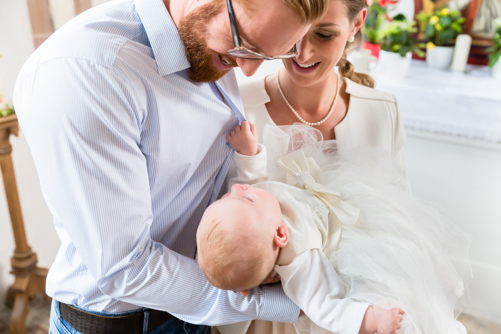 Parents with baby at christening in church