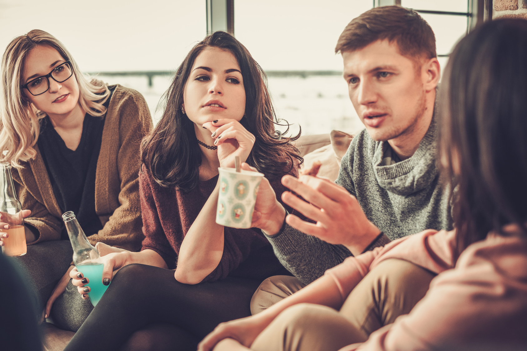 Group of multi ethnic young friends having fun in home interior