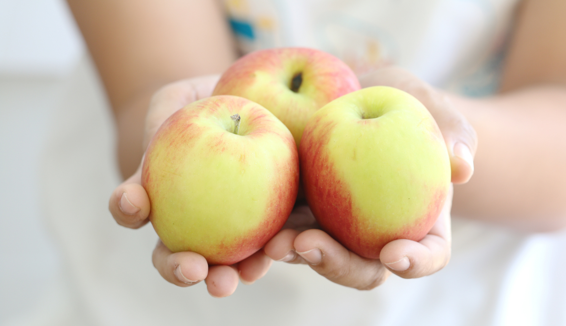 Woman holding apple.