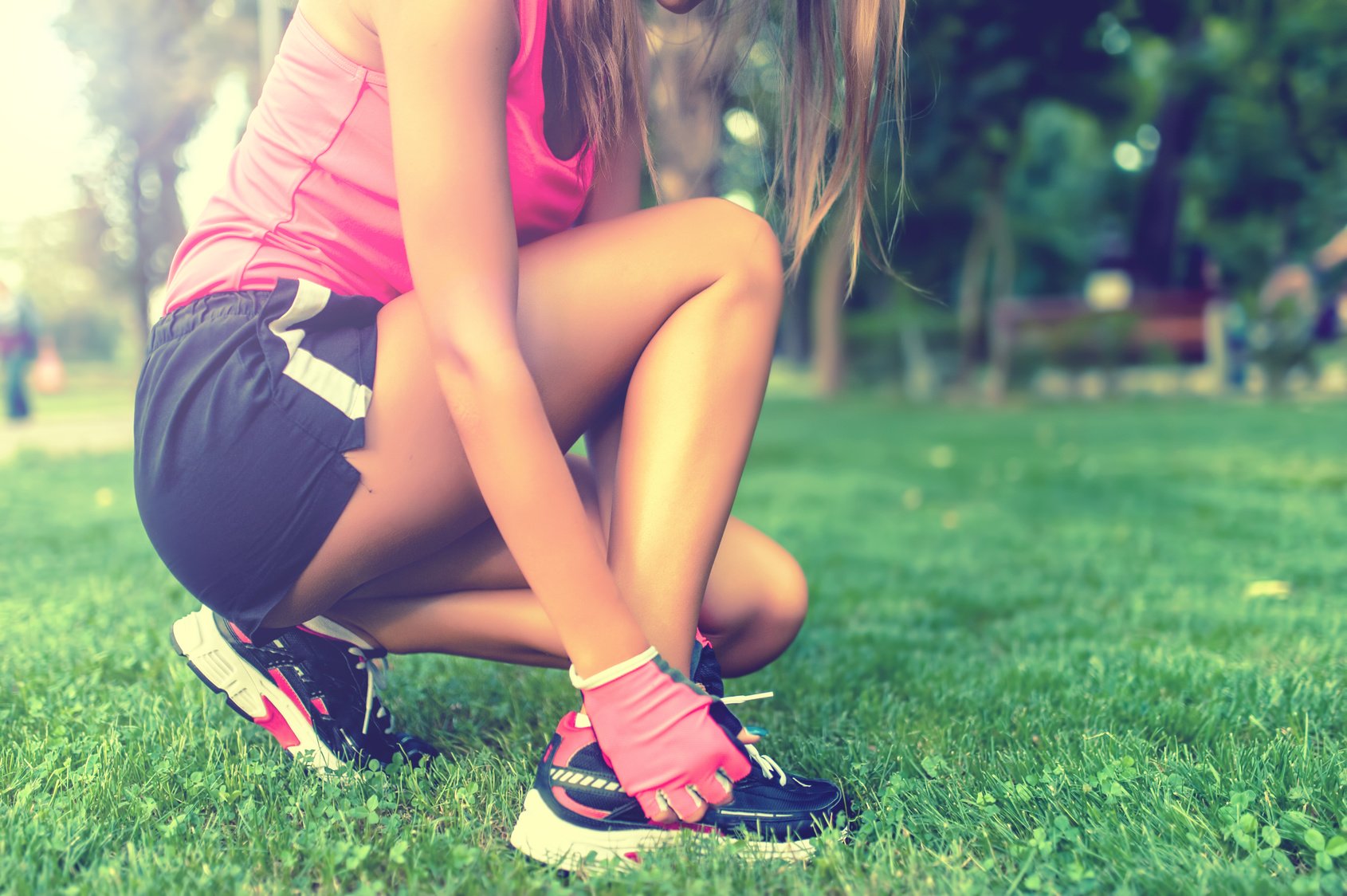 Close-up of active jogging female runner, preparing shoes