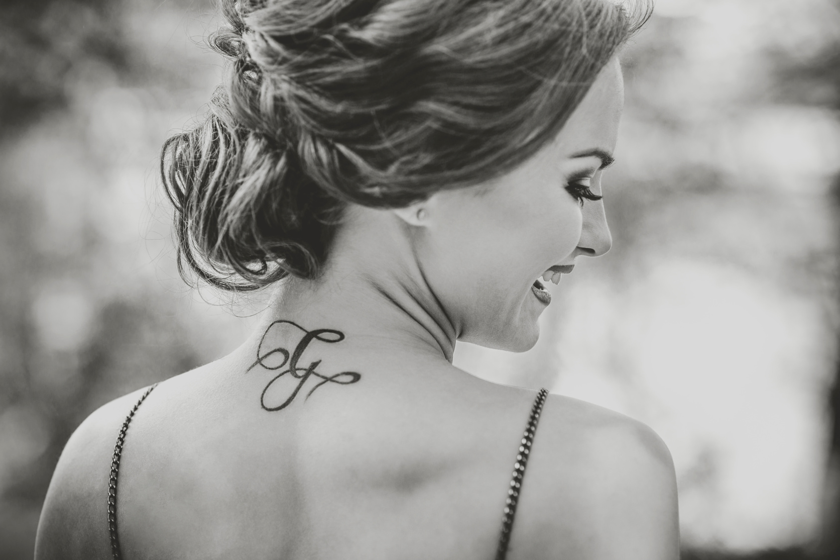 Portrait of young girl with tattoo on the neck