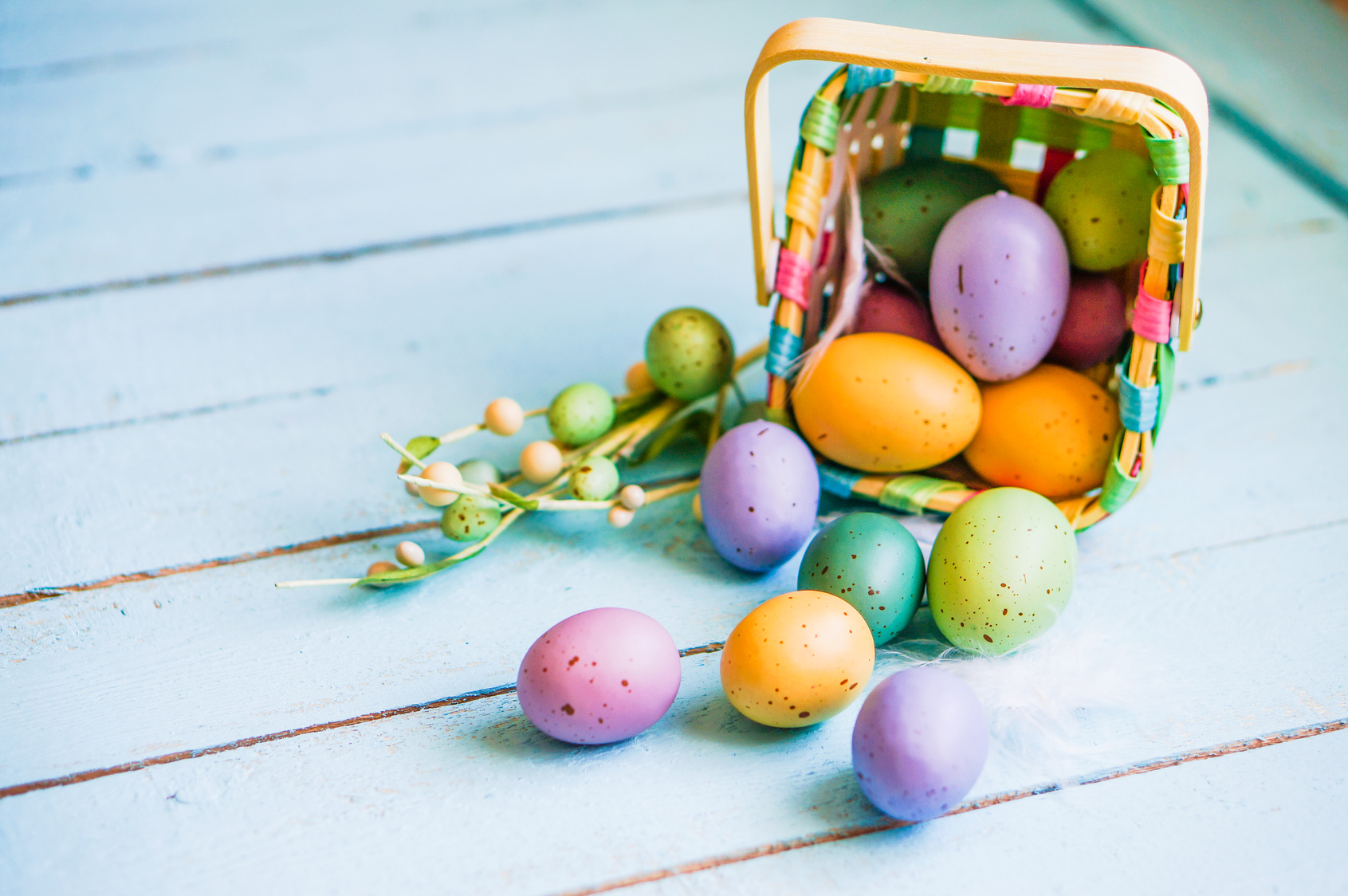 Easter eggs in the basket on blue wooden background