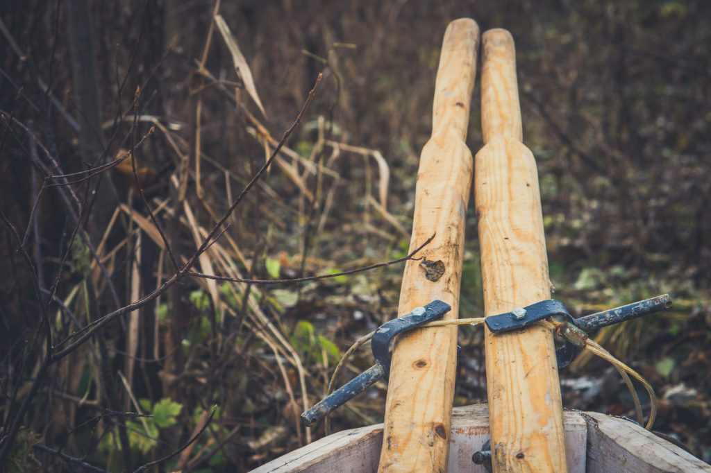 An old wooden boat with oars, rope and other gear. Closed oars