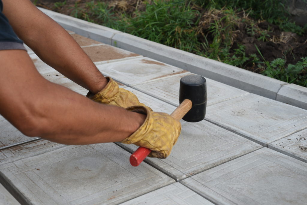 Man with Rubber Mallet Paving