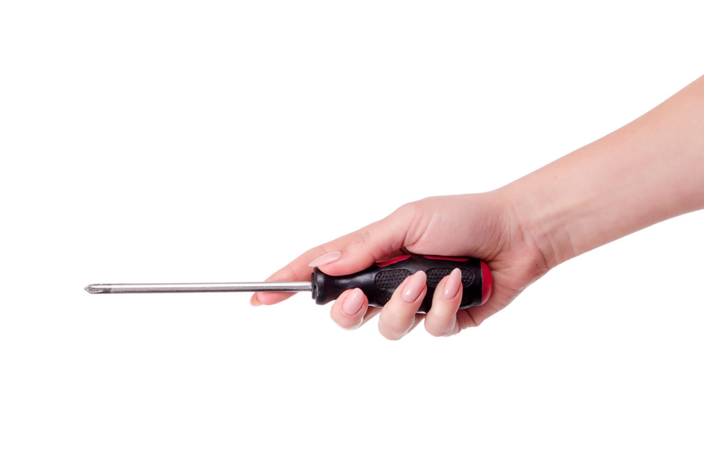 female hand with a screwdriver on a white background close-up