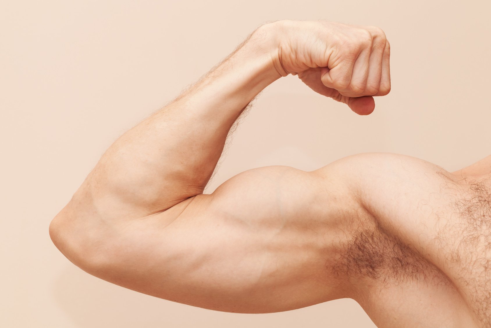 Strong male arm with biceps. Close up photo