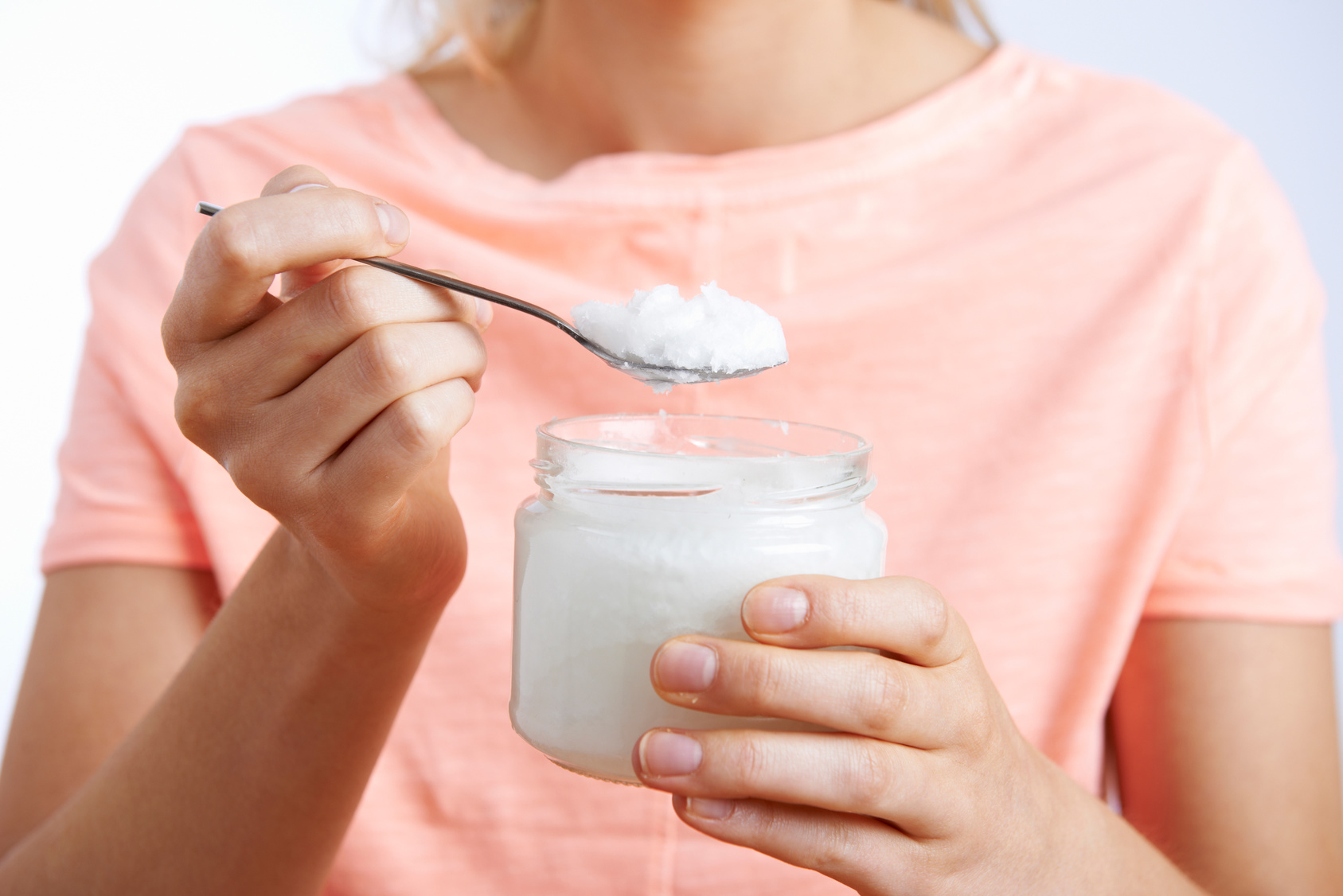 Close Up Of Woman With Spoonful Of Coconut Oil