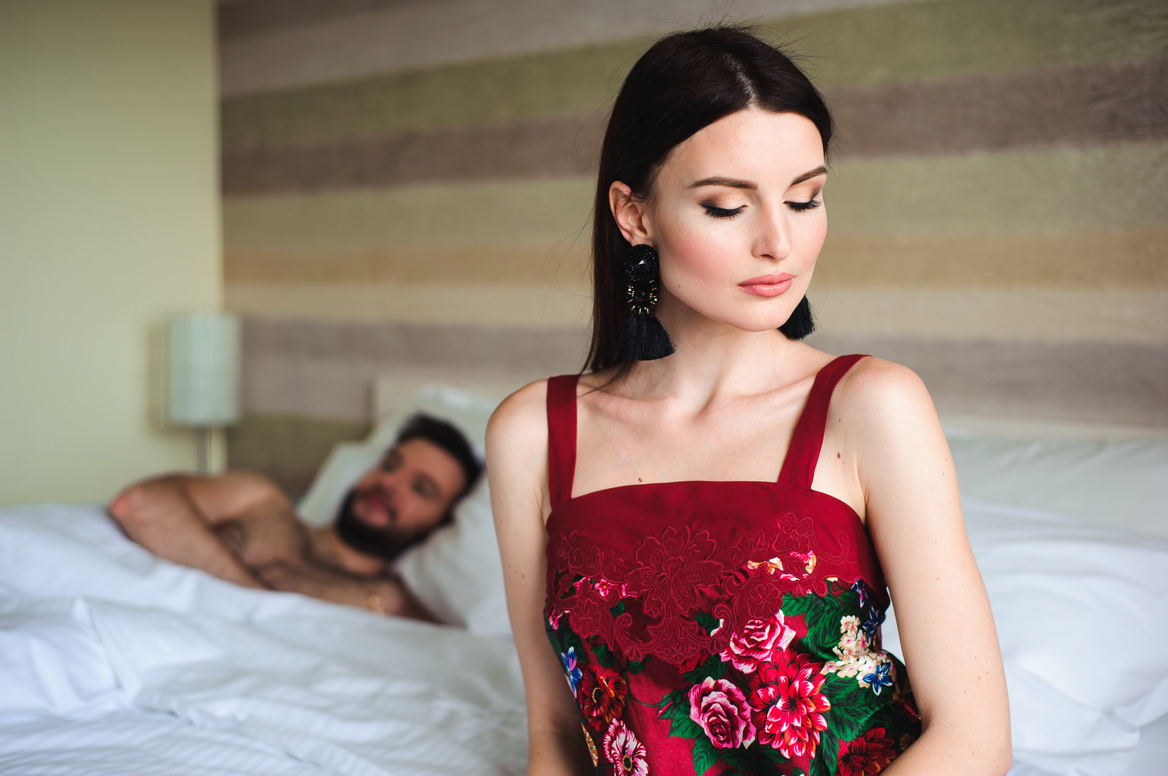 Couple in bed, portrait of a sad woman in bed with her husband