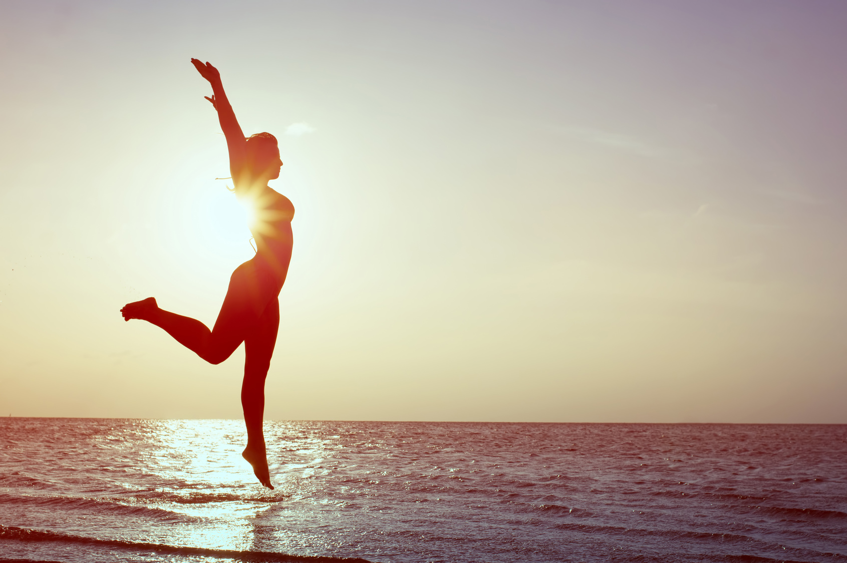 Happy Woman Jumping on the beach