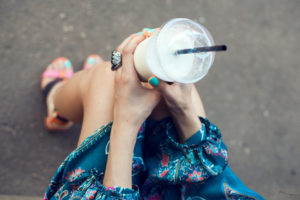 Woman with glasses drinking milkshake