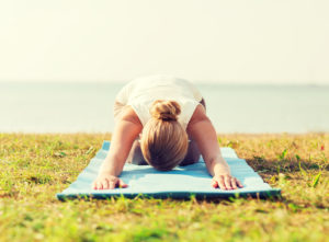 close up of woman making yoga exercises outdoors