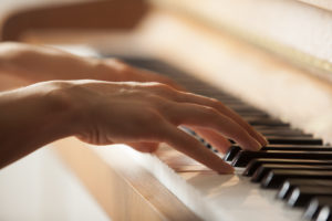 woman hands playing piano