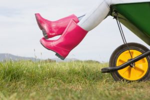 Woman sitting in a wheelbarrow