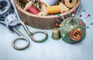still life of spools of thread on a wooden background