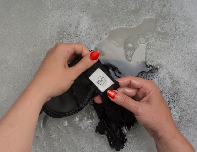 Woman pov washing a bra with hard wash label