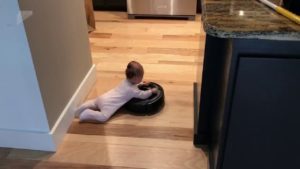 Isän ja pienen vauvan siivouspäivä muuttui leikiksi – vauva pääsi ”kiertoajelulle” robotti-imurilla