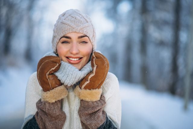 Portrait of happy woman in winter park