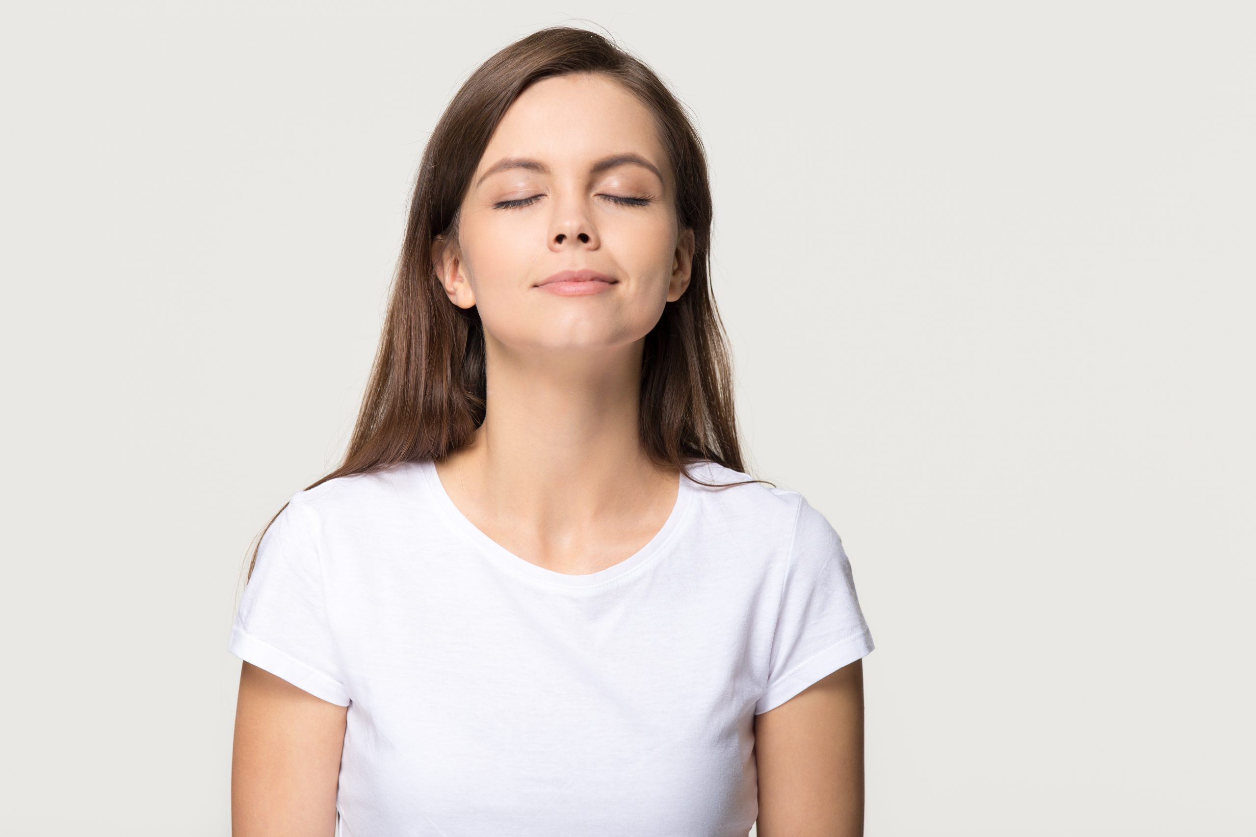 Happy calm girl enjoying good smell breathing fresh air isolated