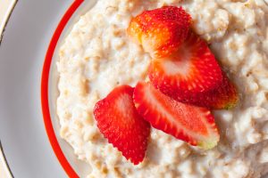 healthy breakfast of oatmeal with strawberries, close up