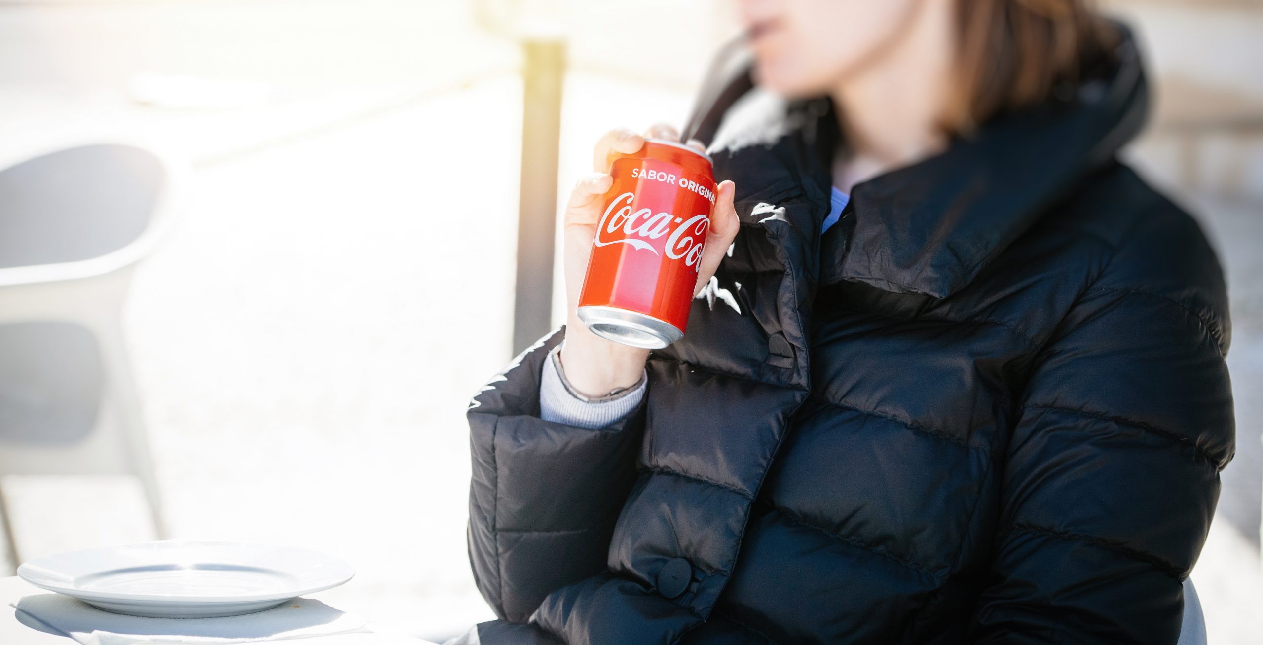 Elegant fashionable woman drinking Soda Can with straw Cola