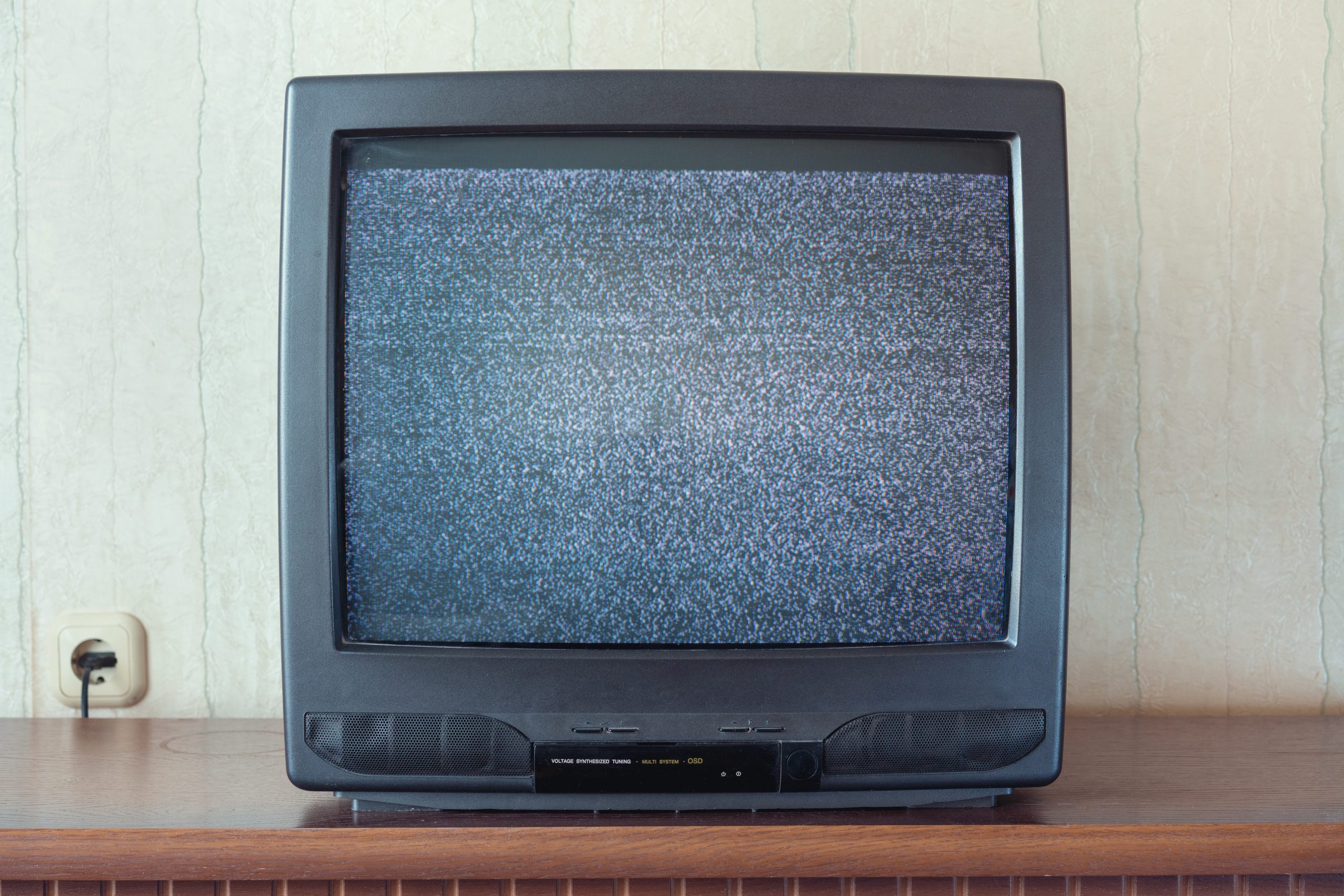 glith television analog signal on tv screen on wooden stand closeup